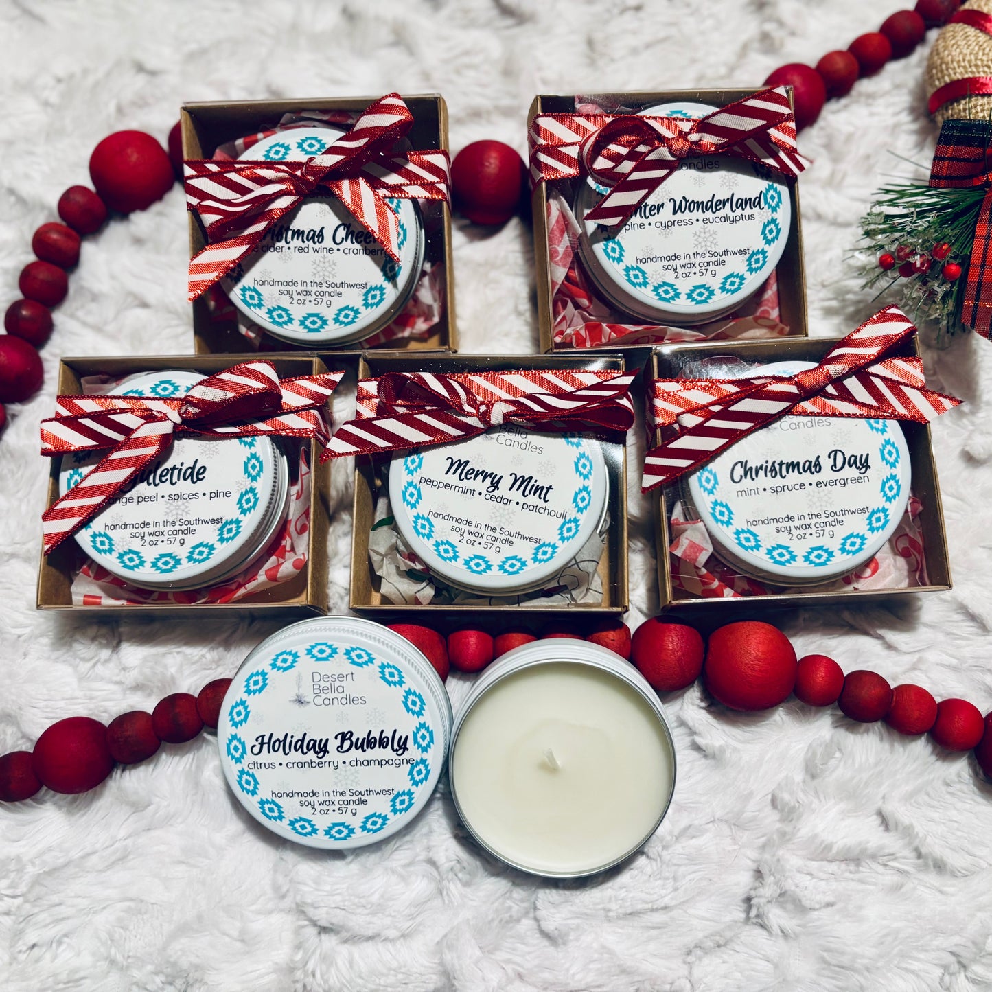 White winter candle packaging with decorative ribbon on a textured surface