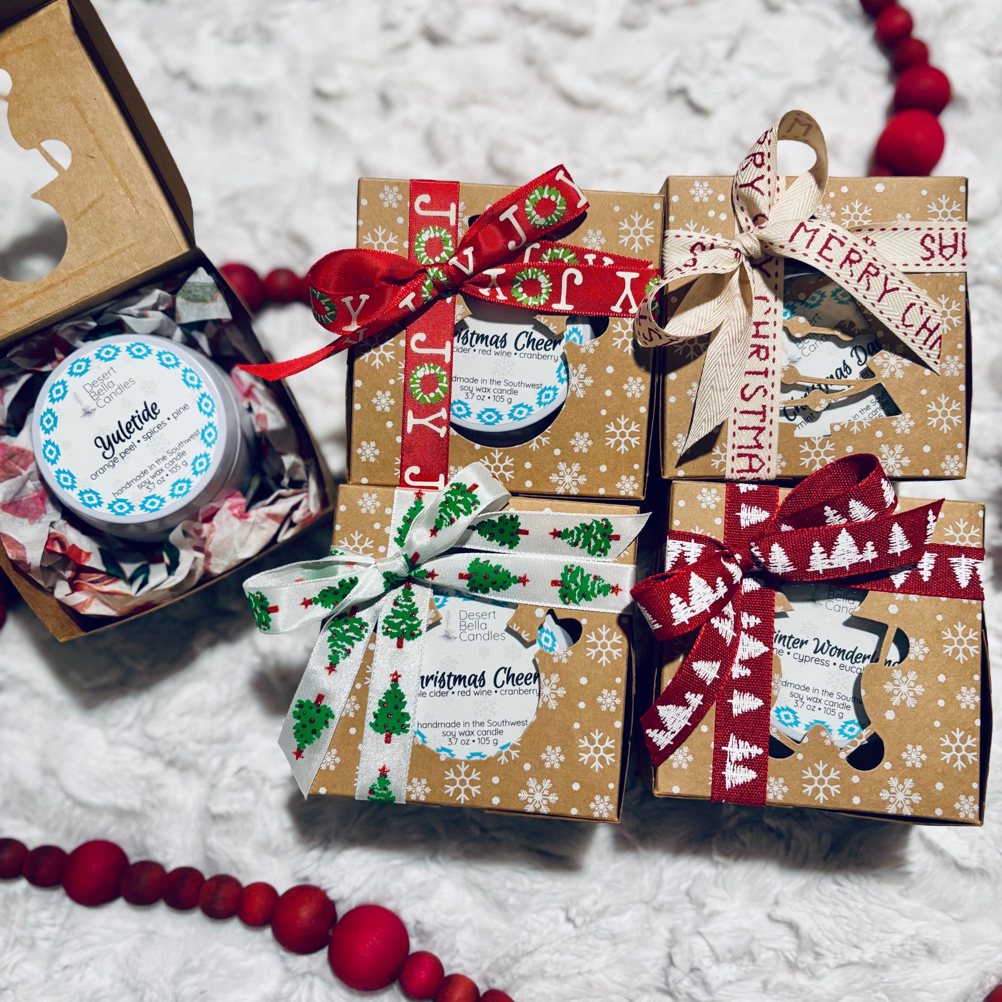 Candle gift boxes with Christmas ribbon in decorative, gift-ready boxes.